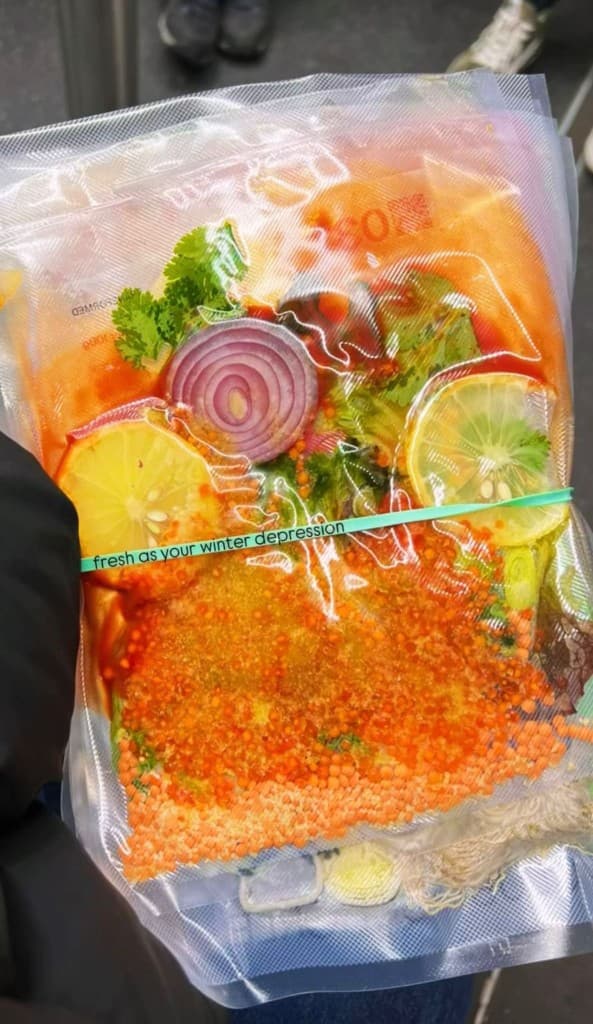 Vacuum-sealed bag with ingredients and handwritten tape label